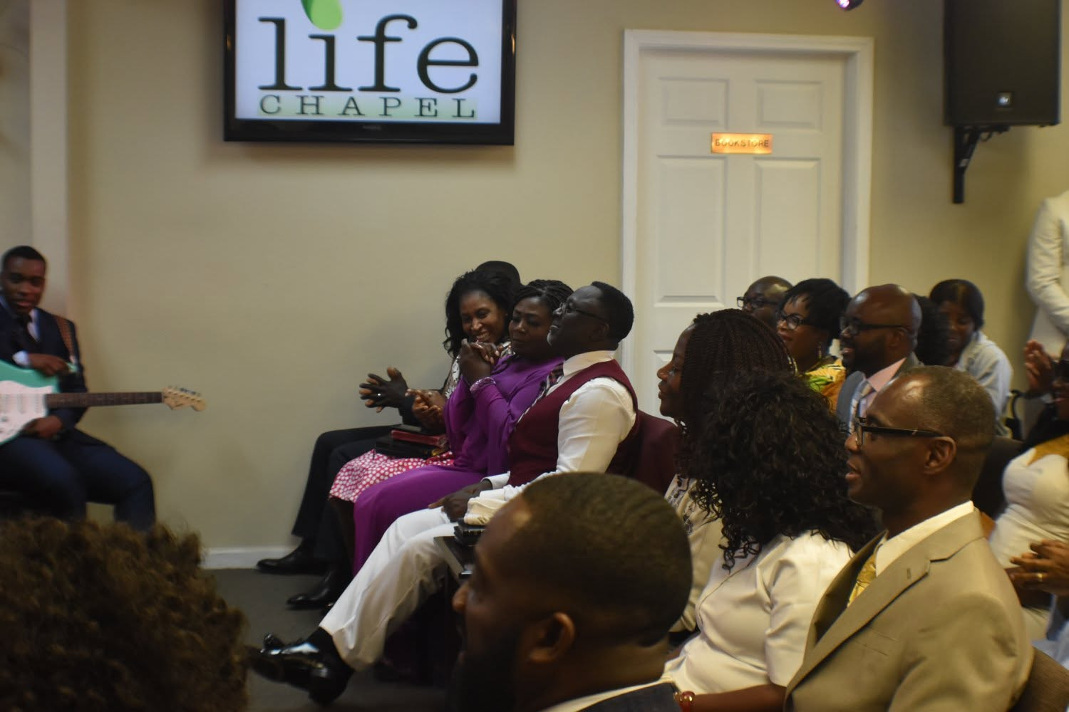 Life Chapel congregation worshipping together beneath the logo screen in 2018
